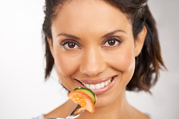 Image showing Happy woman, portrait and vegetable salad for diet, snack or natural nutrition against a studio background. Closeup of female person smile and eating organic food for fiber, vitamins or healthy meal