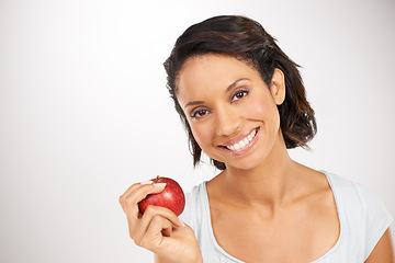 Image showing Happy woman, portrait and apple for health diet, snack or natural nutrition against a studio background. Face of female person or model smile with red organic fruit for fiber, vitamin or healthy meal