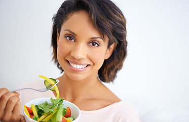 Image showing Eating, salad and portrait of happy woman with nutrition, health and wellness in diet. Healthy food, fruit and vegetables in bowl for lunch on sofa in home living room with happiness and a smile