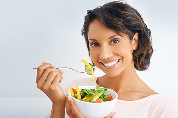 Image showing Happy woman, portrait and vegan with salad bowl for diet, snack or natural nutrition against a studio background. Face of female person smile eating organic food for fiber, vitamins or healthy meal