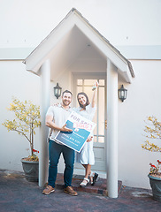 Image showing Couple buying a house together. Couple holding keys in front of their house. Happy couple moving in together. caucasian couple pose outside their new house. Smiling couple outside holding keys