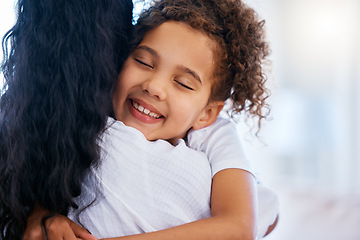 Image showing Happy young mixed race girl hugging her mother. Closeup of little daughter feeling safe and comfortable while showing love and affection to her mom. Girl sharing close bond and relationship with woma
