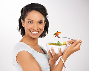 Image showing Happy woman, portrait and fruit bowl for diet, salad or natural nutrition against a studio background. Female person or model smile with organic food, fiber or vitamins for healthy meal and wellness