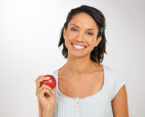 Image showing Happy woman, portrait and apple for natural nutrition, health diet or snack against a studio background. Face of female person or model smile with red organic fruit for fiber, vitamin or healthy meal