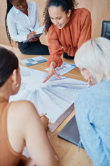 Image showing Close up of a young mixed race woman giving a presentation to a group of female only colleagues at a boardroom meeting in a office. A team of diverse business women planning , brainstorming and strat