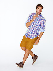 Image showing Portrait, fashion and energy with a man shouting in studio on a white background for trendy hipster fashion. Success, winner and fist for motivation with a young model walking in a clothes outfit