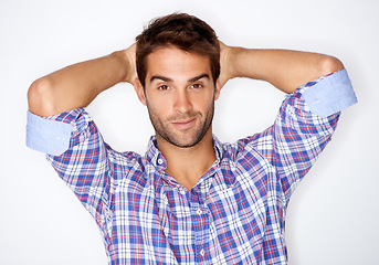 Image showing Portrait, fashion and confident with a trendy man in studio on a white background for clothing style. Face, smile and a happy young model in a clothes outfit to relax in casual wear for comfort