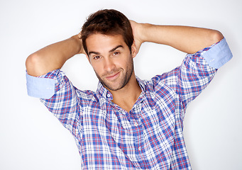 Image showing Portrait, confident and smile with a fashion man in studio on a white background for trendy style. Face, clothes and a happy young model in a clothing outfit to relax in casual wear for comfort