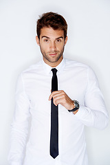Image showing Portrait, fashion and tie with a business man in a shirt in studio on a white background for corporate style. Work, employee and a confident young model in a professional clothes outfit for his job