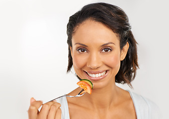 Image showing Happy woman, portrait and smile with vegetables for diet, snack or natural nutrition against a studio background. Face of female person or model with organic food for fiber, vitamins or healthy meal