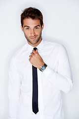 Image showing Portrait, fashion and a business man getting ready for corporate work in studio on a white background. Face, shirt and tie with a confident young employee dressing in a professional clothes outfit