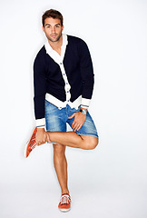 Image showing Portrait, fashion and a man in shorts on a studio white background for trendy style balance. Clothes, casual and outfit with a young model in denim for clothing comfort and relax or confident