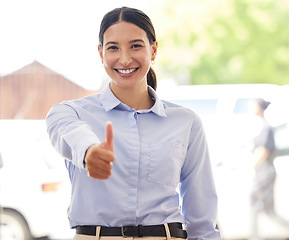 Image showing Believe that you can and youre halfway there. Portrait of a young businesswoman showing thumbs up in an office.