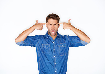 Image showing Portrait, fashion and finger gun with a crazy man in studio isolated on a white background for expression. Mental health, anger and a young model pointing to his temple to gesture a mind blown emoji