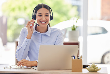 Image showing Always the first to answer your calls. a young call centre agent working on a laptop in an office.