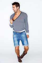 Image showing Sexy, crazy and a man with fashion clothes on a white background with confidence. Shouting, young and a person, model or guy looking cool, stylish or trendy in clothing, shorts or hipster style