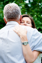 Image showing Senior couple, nature and a hug for love, care and bonding together in retirement. Comfort, elderly and a man and woman with affection, romance or loyalty in a marriage in a garden or park for a date