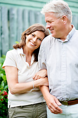 Image showing Senior couple, arm or love with support in marriage, care or wife smile on face in commitment family security. France, mature man or woman with gratitude, embrace or happy together in garden backyard