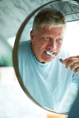 Image showing Mirror, cleaning or mature man brushing teeth with dental toothpaste for oral hygiene grooming in home. Face reflection, morning or senior person with a toothbrush for care, wellness or healthy mouth