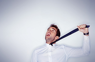 Image showing Stress, mental health and a man choking on his tie in studio on a white background with mockup space. Depression, anxiety and strangle for self harm with an unhappy young person shouting in anger