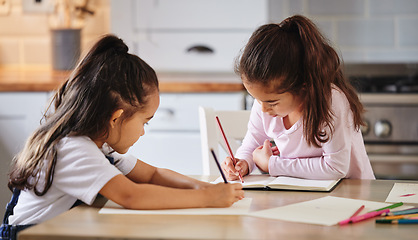 Image showing Being mischievous together. two girls completing their homework together.