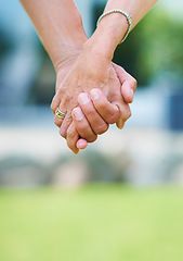Image showing Couple, travel or holding hands for support in park, nature or outdoors on a romantic walk for love. Wellness, freedom or closeup of man with woman bonding, care or enjoying date together outside