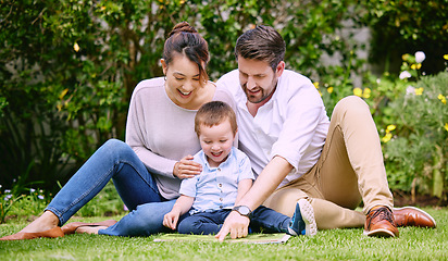 Image showing This is what true happiness looks like. a family reading a book outside.