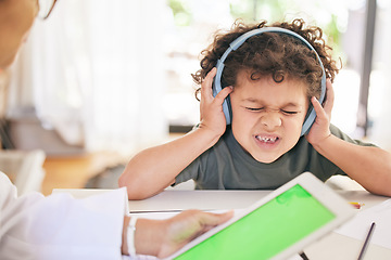 Image showing Youll have to learn how to speak their language. a young boy having trouble expressing himself while consulting with a specialist at home.