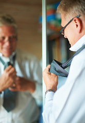 Image showing Mature happy man with mirror, tie and shirt for work in morning in apartment with glasses, clothes or confidence. Face, reflection and professional senior businessman in home getting ready for office