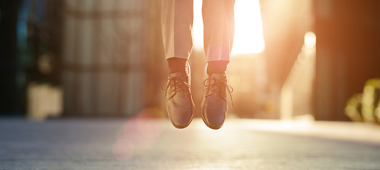 Image showing Feeling as though he could float. a businessman jumping mid air.