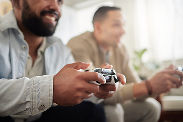 Image showing Round one. Lets go. two men playing video games while sitting on a couch together.