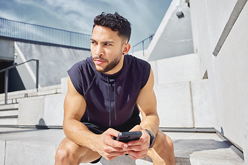 Image showing Ill do this at my own pace. a sporty young man using a cellphone while exercising outdoors.