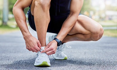 Image showing Lace up and give it your all. Closeup shot of an unrecognisable man tying his laces while exercising outdoors.