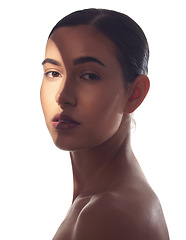 Image showing My skin feels. Studio shot of a beautiful young woman posing with light beam against her face.