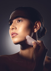 Image showing Trust the process. Studio shot of a woman using a face scraping tool on her face.