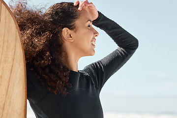 Image showing Live to surf, surf to live. Shot an attractive young woman posing with her surfboard and going out to surf at the beach.