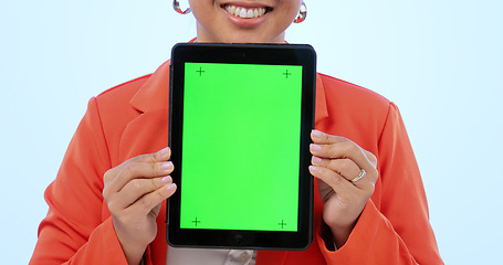 Image showing Woman, hands and tablet with green screen in studio by blue background. Female model, tracking markers and chroma key on digital device, technology and display or promotion, online and mock up