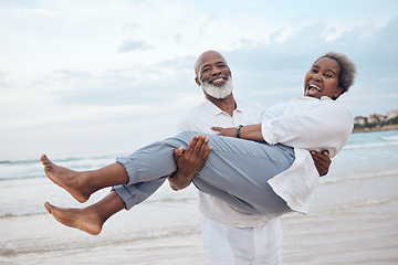 Image showing Be careful, dont trip on your cape. a mature couple spending time at the beach.