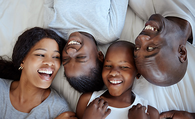 Image showing I sustain myself with the love of family. a beautiful young family bonding in bed together.