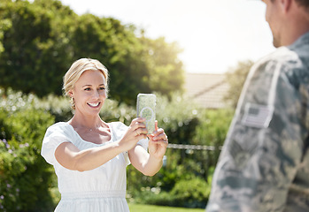 Image showing A supportive family is what builds a home. a wife taking a picture of her husband outside.