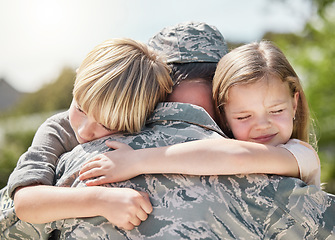 Image showing The world, wed discovered, doesnt love you like your family. a father returning from the army hugging his children outside.