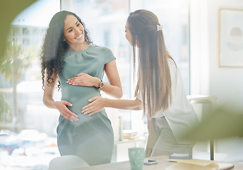 Image showing Thank you for supporting my at work through my pregnancy. a businesswoman touching her colleagues pregnant belly in an office.