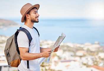 Image showing Ill find my way to the next adventure. a young man holding a map while exploring outdoors.