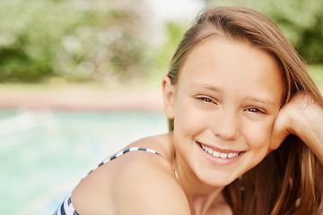 Image showing Being in the pool cools me off. an adorable little girl outside on a sunny day.