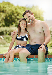 Image showing She loves swimming as much as I do. a man and his daughter bonding by the poolside.