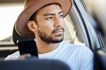 Image showing Good company in a journey makes the way seem shorter. a young man sitting in a car while using his phone.