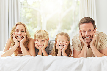 Image showing Family time always takes priority. a beautiful young family bonding in bed together.