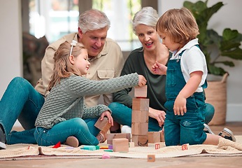 Image showing Cant reach up too high. a mature couple bonding with their grandkids at home.