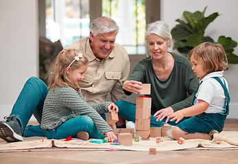 Image showing Love lives in these building blocks. a mature couple bonding with their grandkids at home.