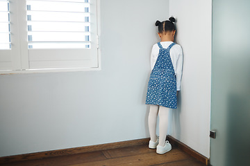 Image showing Hurt little tender heart. an unrecognizable little girl facing the wall and as punishment in a room at home.